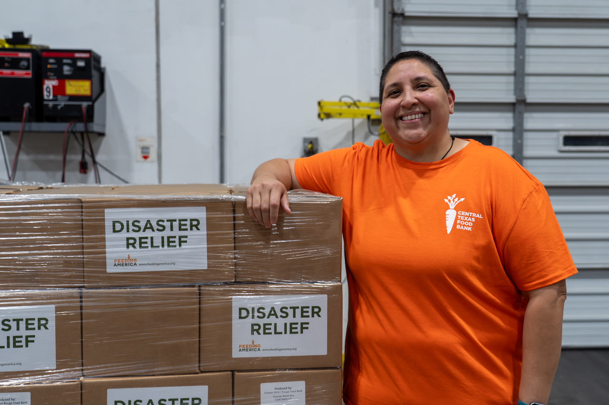 Cindy next to Disaster Relief boxes