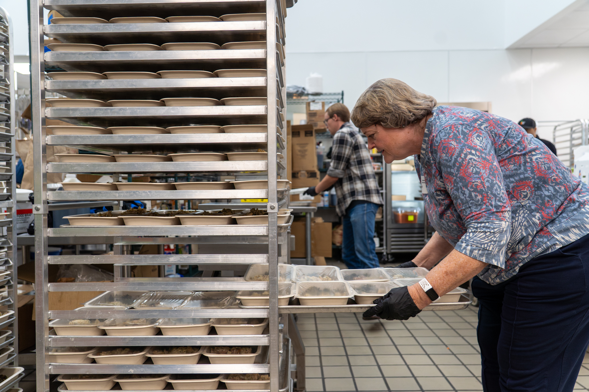Tracy Henderson volunteers in the kitchen preparing meals.