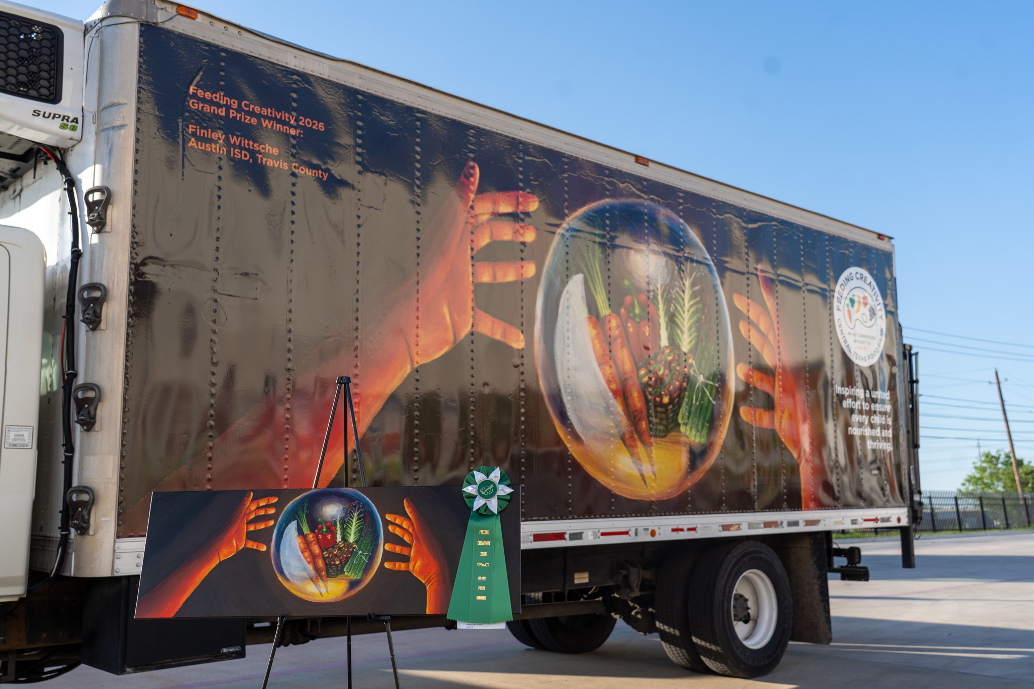 Feeding Creativity 2026 Winning Art Displayed Next to Delivery Truck with Winning Art