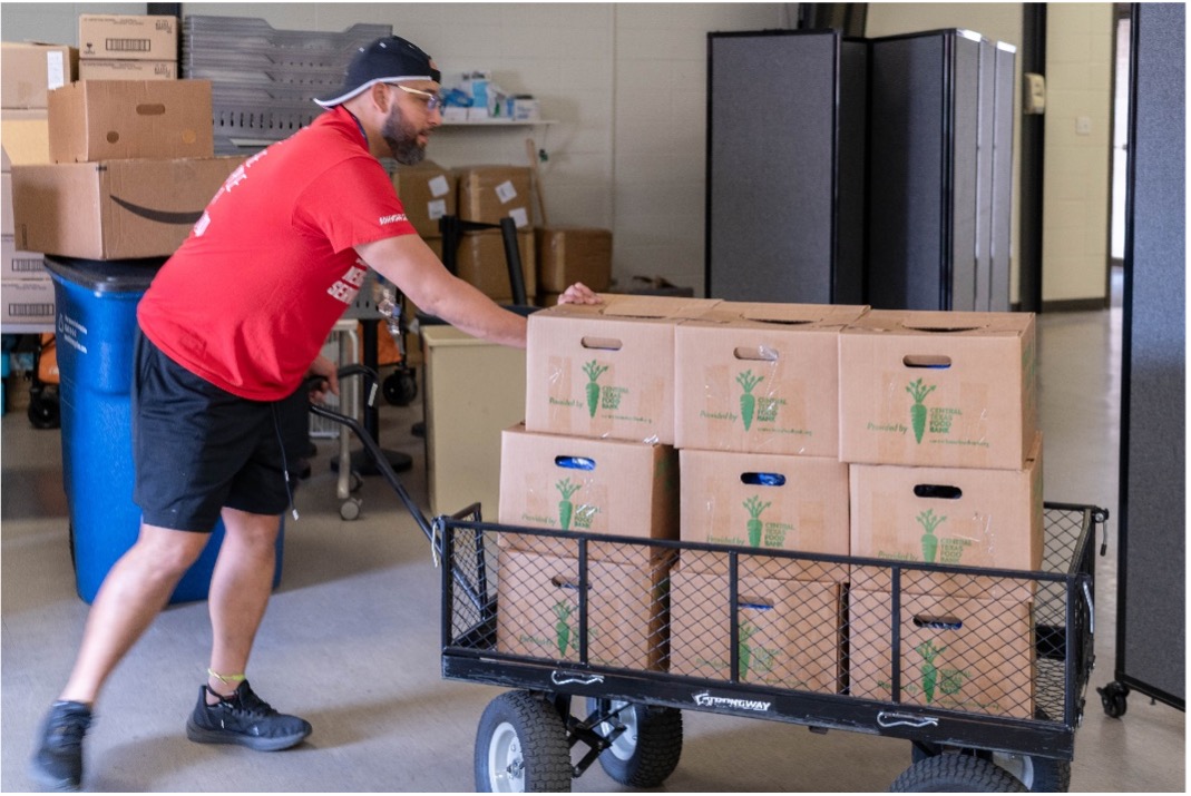 Food Bank volunteer moving disaster boxes with food