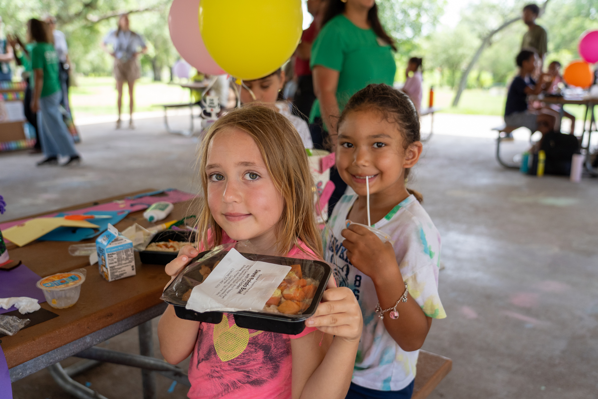 Children in Austin eat free summer meals provided by the Central Texas Food Bank.