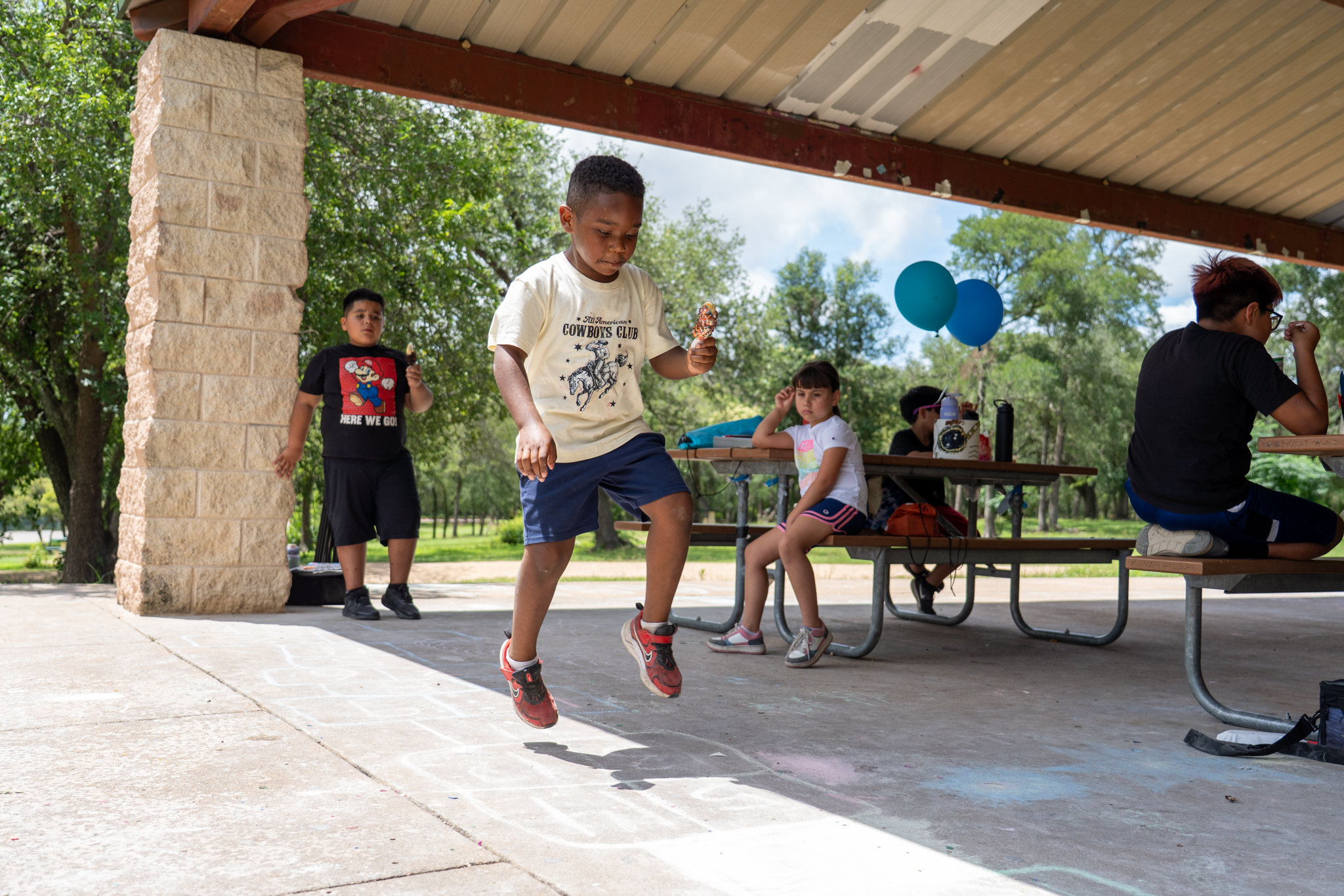 A boy plays after eating a free summer meal provided by the Central Texas Food Bank.
